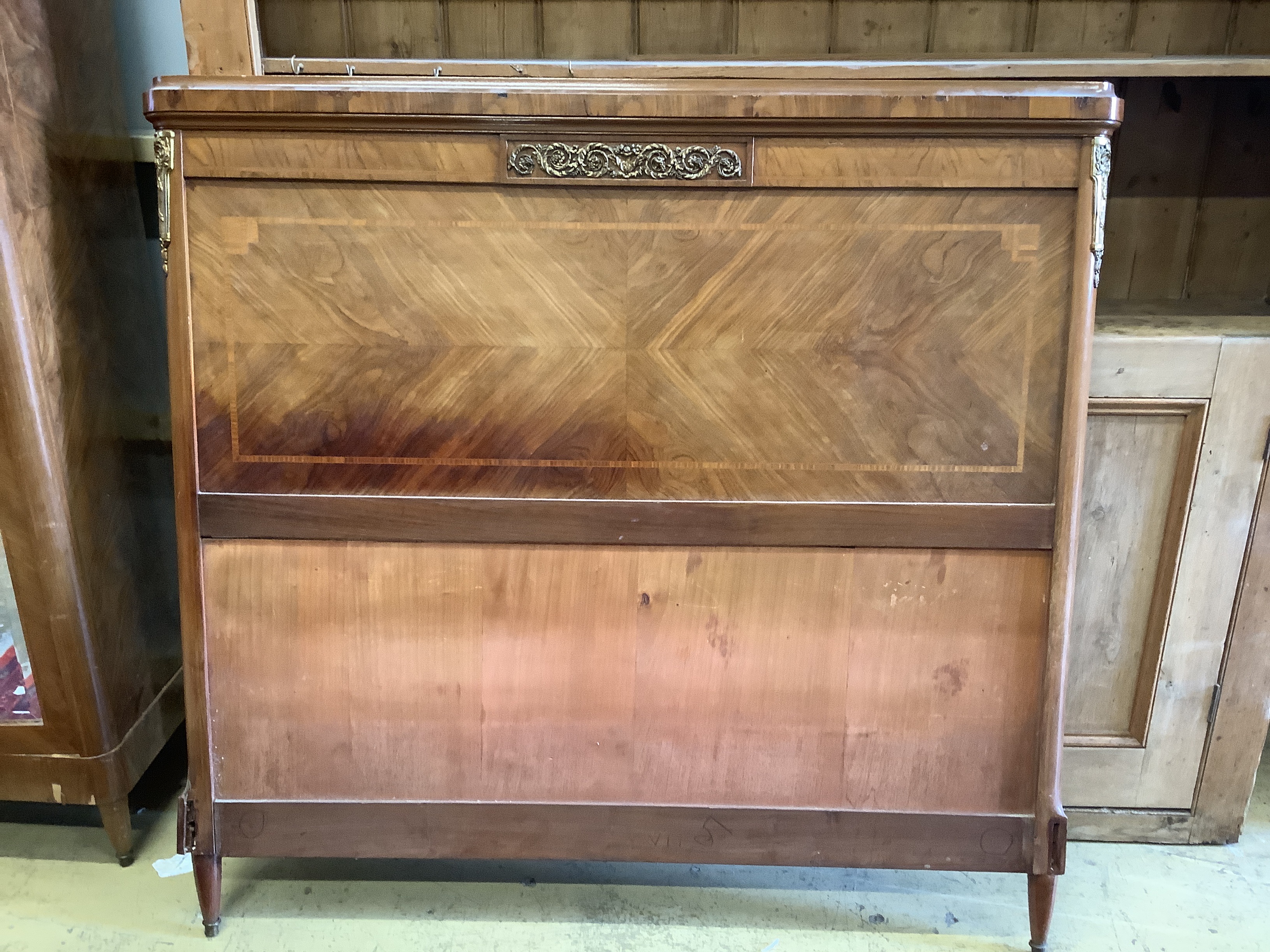 An early 20th century French gilt metal mounted kingwood mirrored armoire, width 120cm, depth 47cm, height 218cm together with a matching headboard